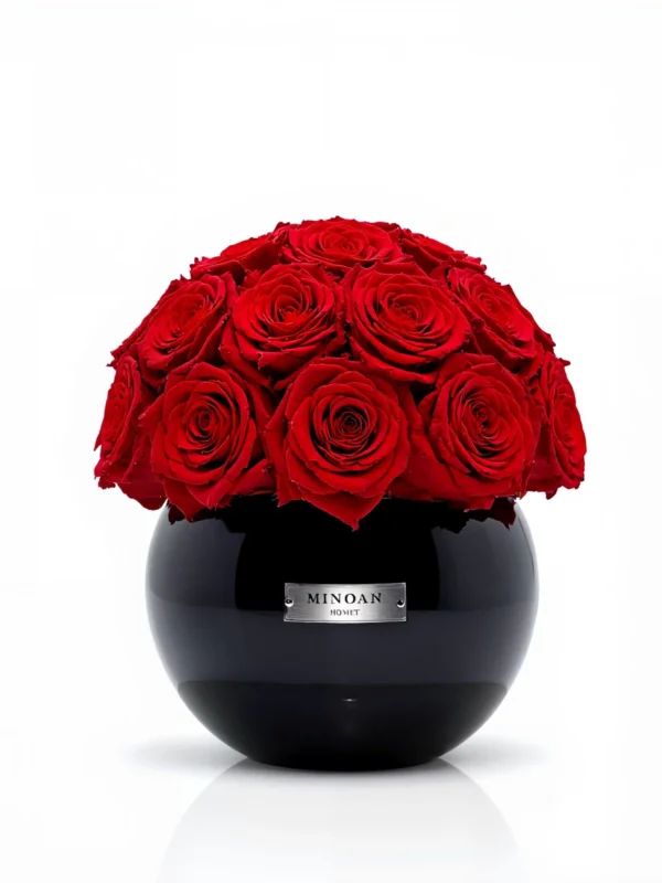 Glossy black Minoan Homey vase with deep red roses, luxurious floral arrangement on reflective surface