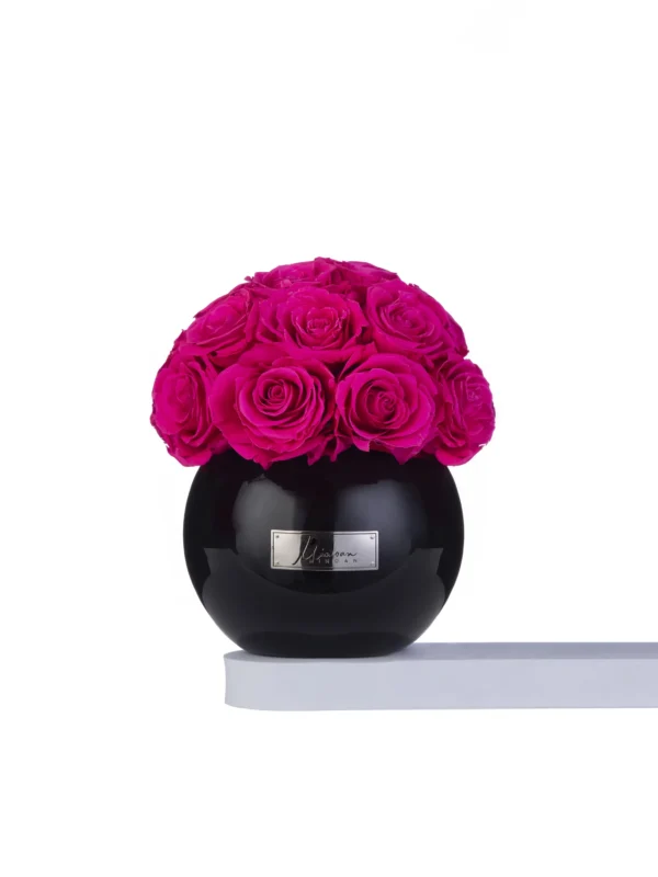 Glossy black vase with lush pink rose bouquet
