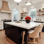 Black vase with red roses on a kitchen island, elegant floral display.
