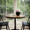 Minimalist dining nook with black vase of white and pink flowers
