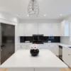 Contemporary kitchen with black glass backsplash and white-pink rose bouquet