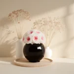 Minimalist floral arrangement with white and pink roses in black vase