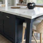Farmhouse-style kitchen with navy blue island and wooden shelves