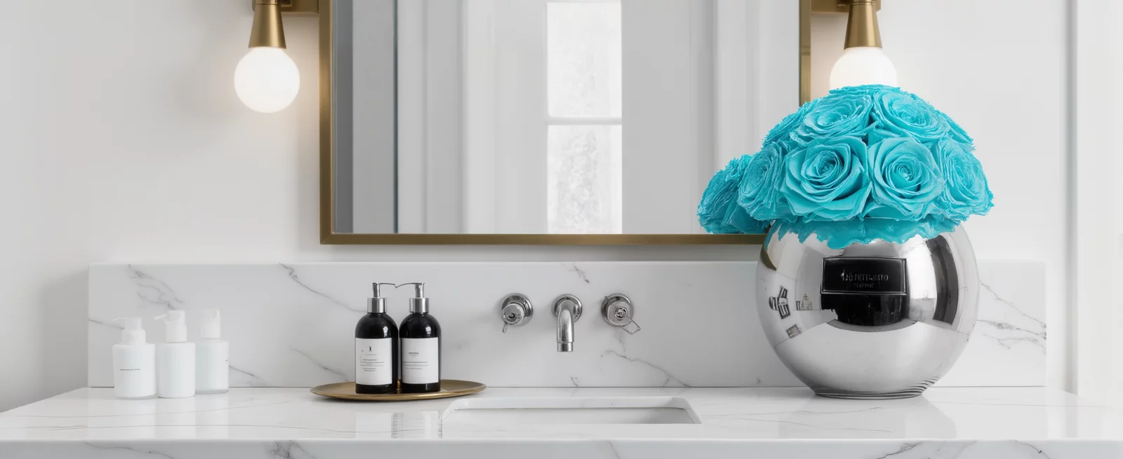 Elegant bathroom vanity with silver vase of blue roses and brass sconces
