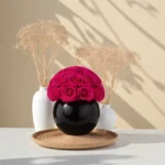 Minimalist arrangement with magenta roses and dried wheat stalks