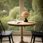 Cozy corner with wooden table, cream flowers, and garden view