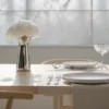 Modern kitchen with white island, black base, and dual floral vases