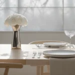 Modern kitchen with white island, black base, and dual floral vases
