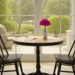 Cozy dining nook with wooden table, magenta rose, and garden view