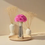 Minimalist floral arrangement with pink roses and dried wheat stalks