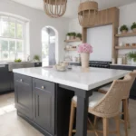Modern kitchen with white island, wooden hood, and pink rose bouquet