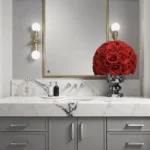 Minimalist bathroom with white marble countertop and red roses