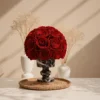 Minimalist floral arrangement with red roses in black and white marble vase