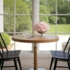 Serene dining nook with wooden table, pink roses, and garden view