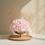 Delicate pink rose bouquet in metallic vase with rustic dried flowers