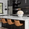 Modern kitchen with black cabinetry, white floral arrangement, and black accents