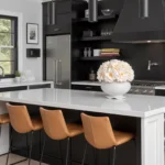 Modern kitchen with black cabinetry, white floral arrangement, and black accents