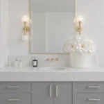 Modern bathroom with white marble countertop and large white floral bouquet