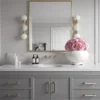 Elegant bathroom sink area with grey vanity and pink rose bouquet