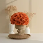 Rustic wooden pedestal with artificial orange rose bouquet