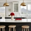 Modern kitchen with white marble island, mountain view, and red roses
