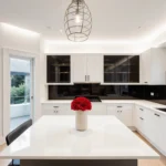 Contemporary kitchen with black glass-paneled cabinets and red roses