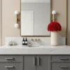 Modern bathroom with white marble countertop and red rose bouquet