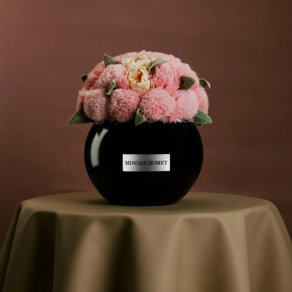 Black ceramic vase named "Minga Honey" with fluffy pink peonies bouquet on beige cloth-covered table