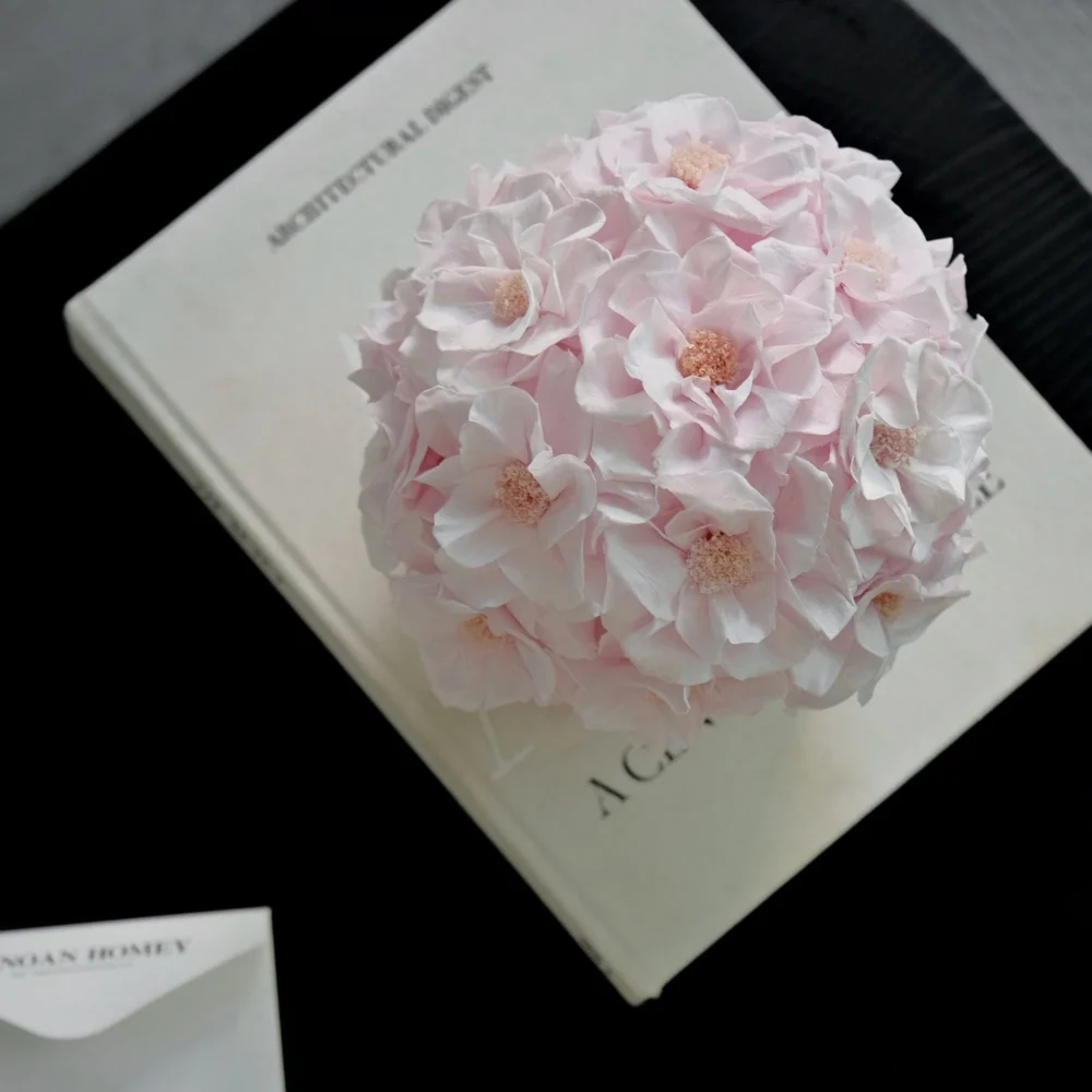 Delicate pink hydrangea bouquet on open cream-colored book titled Northern Lights