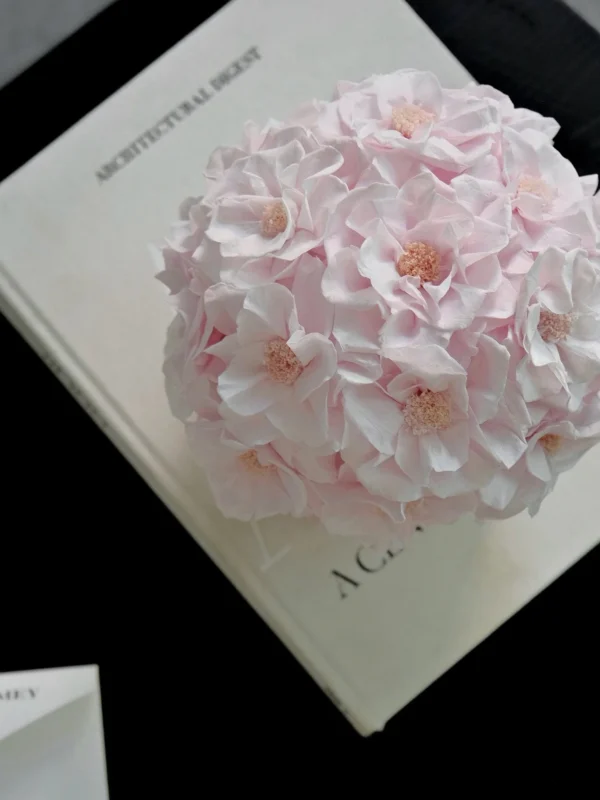 Delicate pink hydrangea bouquet on open cream-colored book titled Northern Lights
