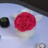 White textured ceramic vase with pink roses bouquet