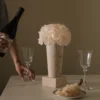 Minimalist table setting with beige stone vase of cream hydrangeas