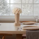 Scandinavian dining room with white flowers and snowy landscape backdrop