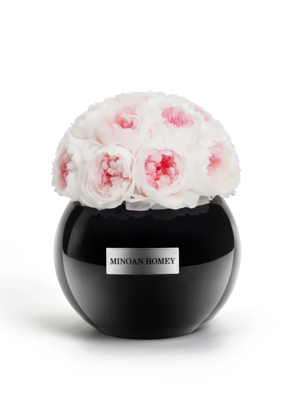 Black glossy vase labeled "MINGON HOMEY" containing bouquet of white roses with pink accents on white background