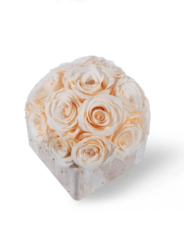 Square white ceramic box adorned with lush bouquet of cream-colored roses against stark white background