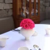Formal table setting with white vase containing pink roses