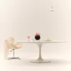 Minimalist dining setup with black vase of pink flowers