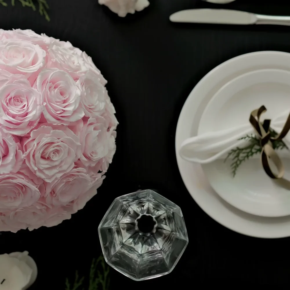 Stylish table setting with pale pink paper rose bouquet and white ceramic plate