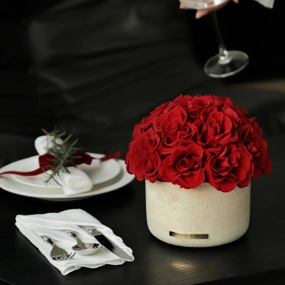 Elegant table setting with beige vase of red roses