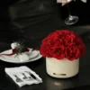 Elegant table setting with beige vase of red roses