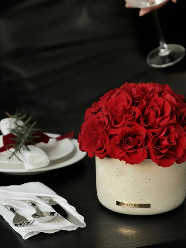 Elegant table setting with beige vase of red roses