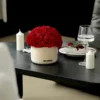 Minimalist dining setup with red roses and candles