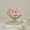 Delicate silver bowl filled with soft pink hydrangeas on elegant table setting