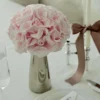 Elegant table setting with silver vase of pale pink roses