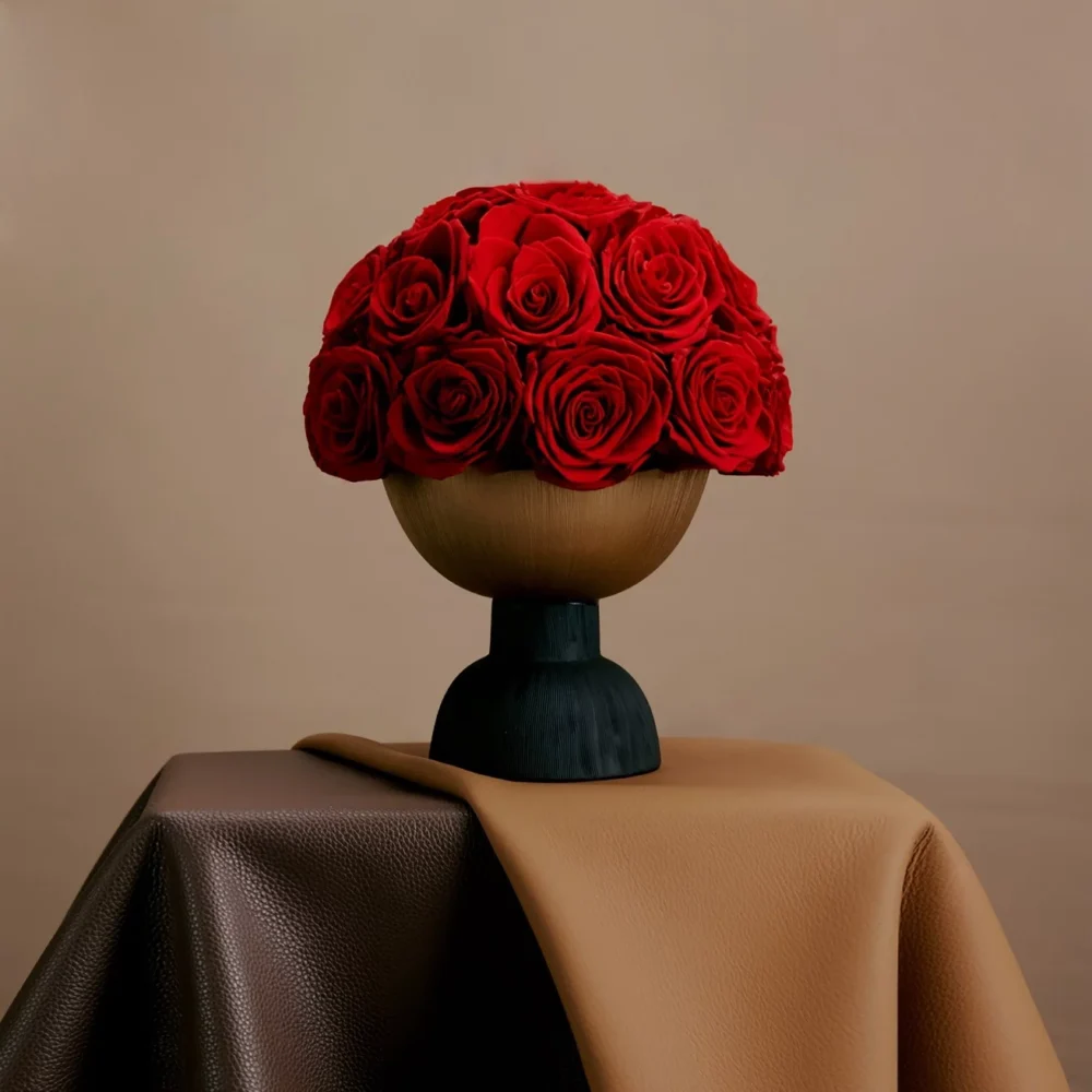 Minimalist floral arrangement with red roses in sleek modern vase