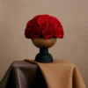 Minimalist floral arrangement with red roses in sleek modern vase