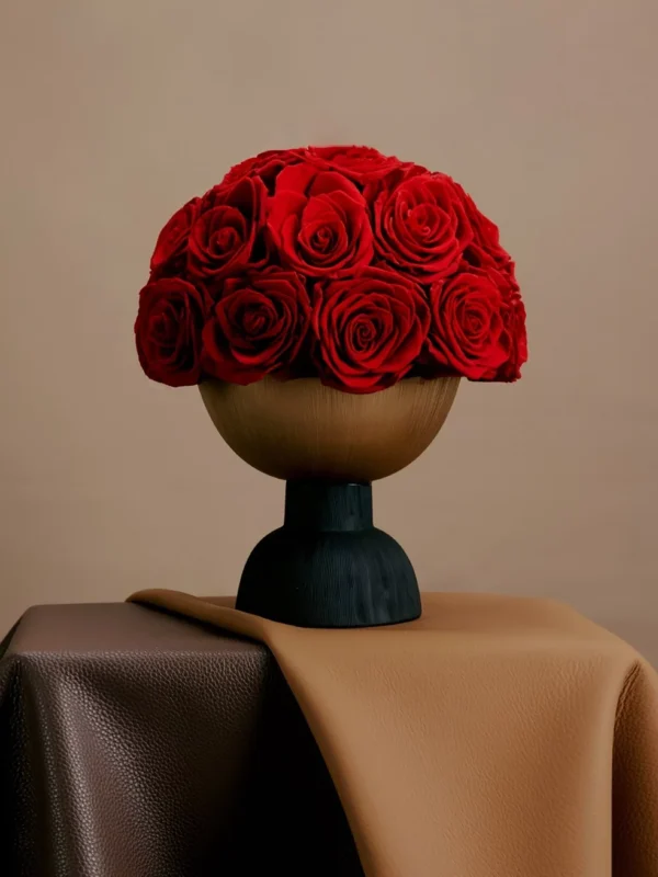 Minimalist floral arrangement with red roses in sleek modern vase