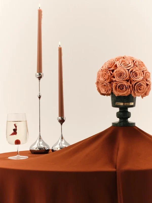 Elegant setup with tall candles and peach-colored roses