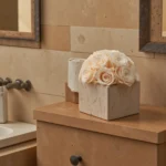 Beige bathroom with vase of cream roses