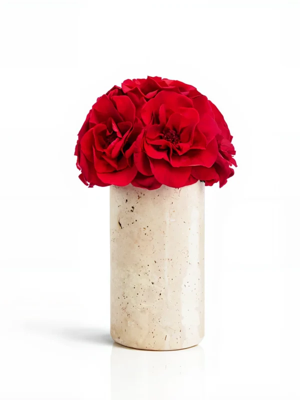 Tall beige marble vase with deep red carnations, elegant floral composition
